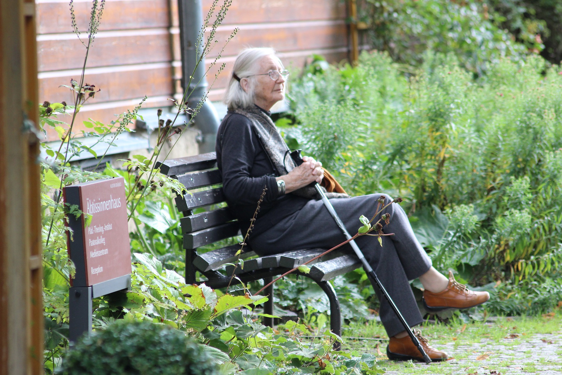 Elderly woman sat on a bench
