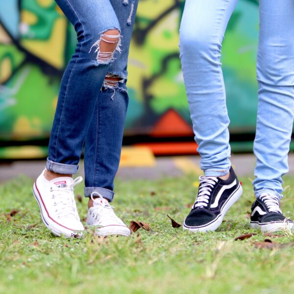 Two people wearing skinny jeans