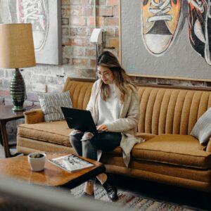 Woman using a laptop on a couch