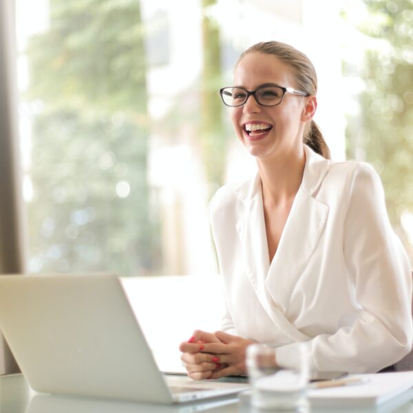 Businesswoman laughing in front of a laptop