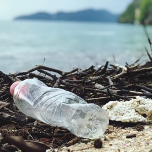 Plastic bottle littering area near water