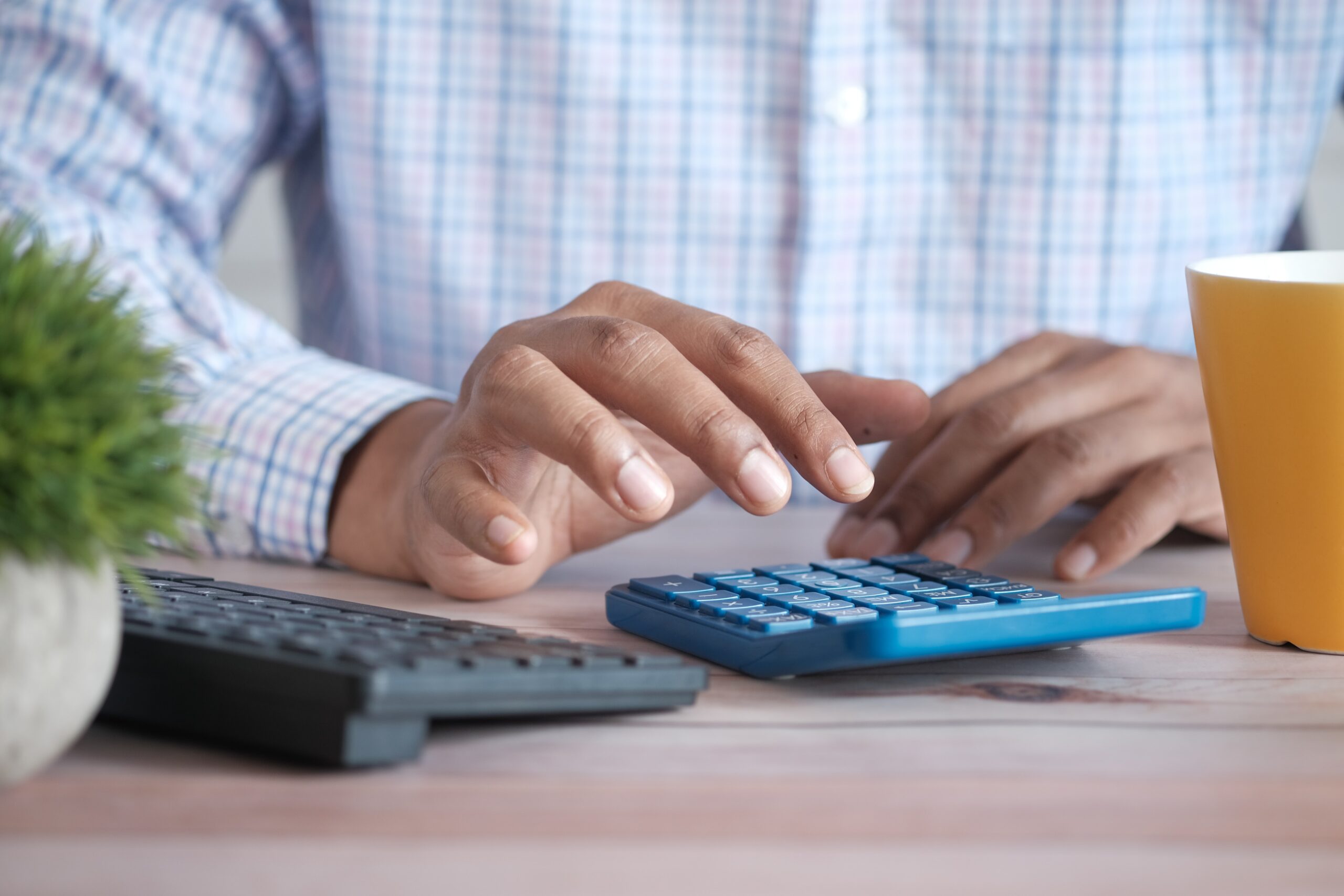 Person using a calculator on a desk