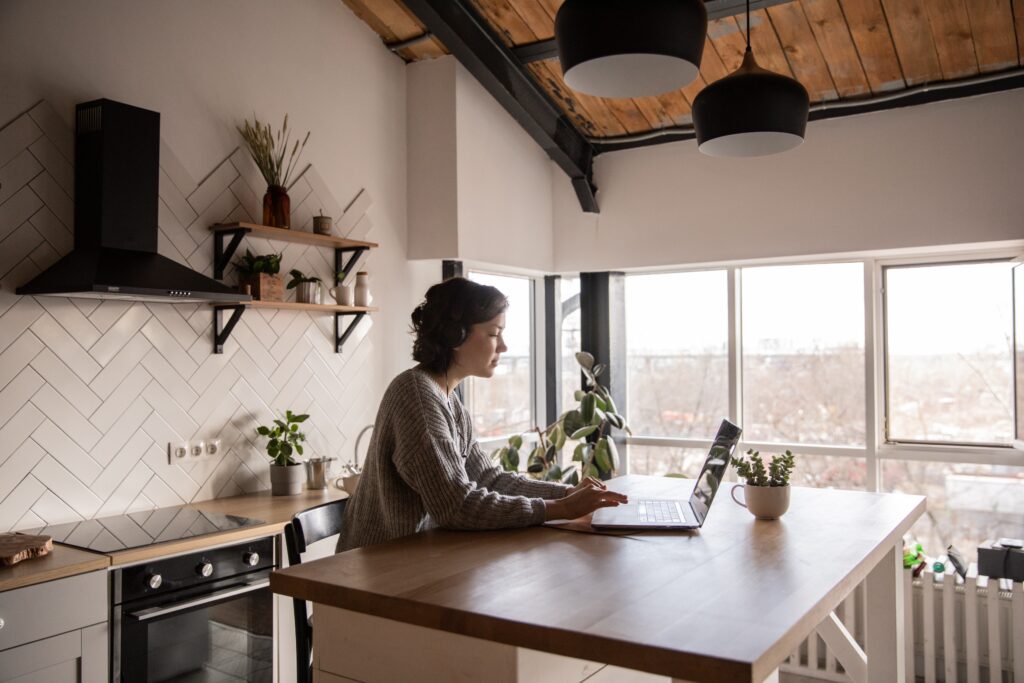 Woman using a laptop in a kitchen