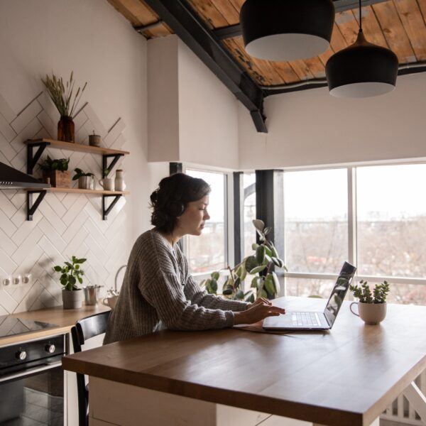 Woman using a laptop in a kitchen