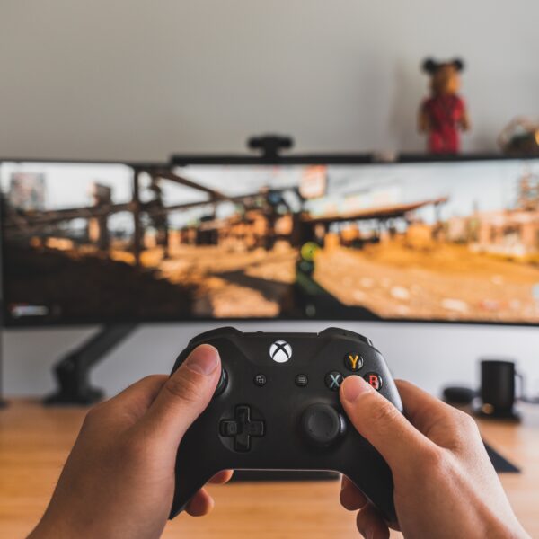 Xbox controller in front of super ultrawide monitor