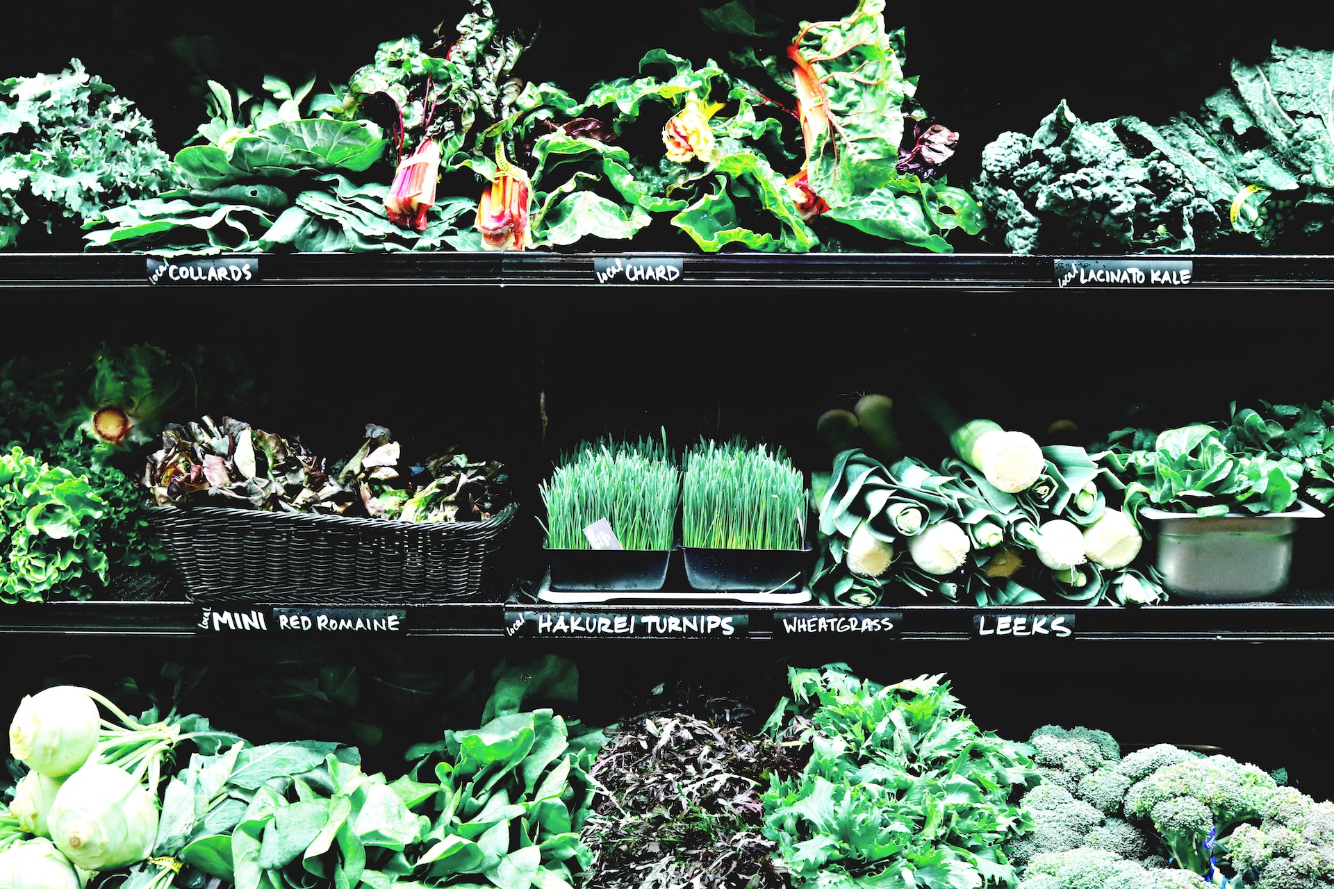 A variety of herbs and vegetables on supermarket shelves