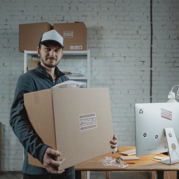 Man in jacket holding a cardboard box
