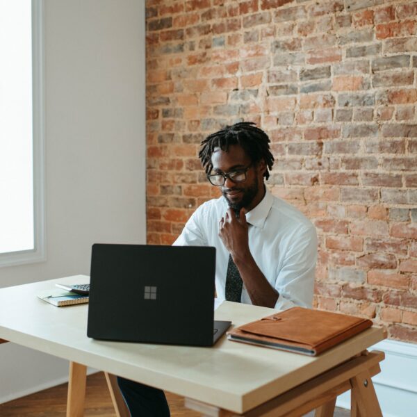 Man sitting at a desk in front of a laptop