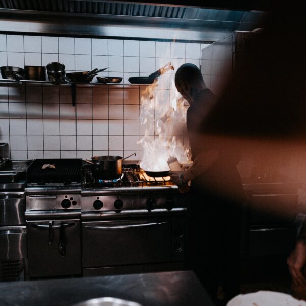 Person cooking in an industrial kitchen