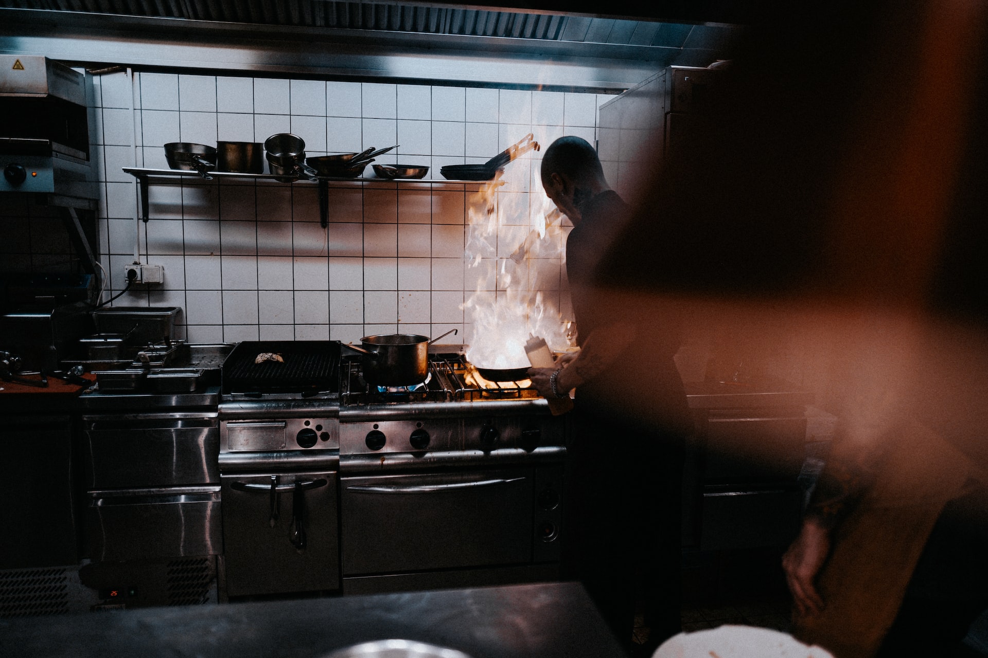 Person cooking in an industrial kitchen