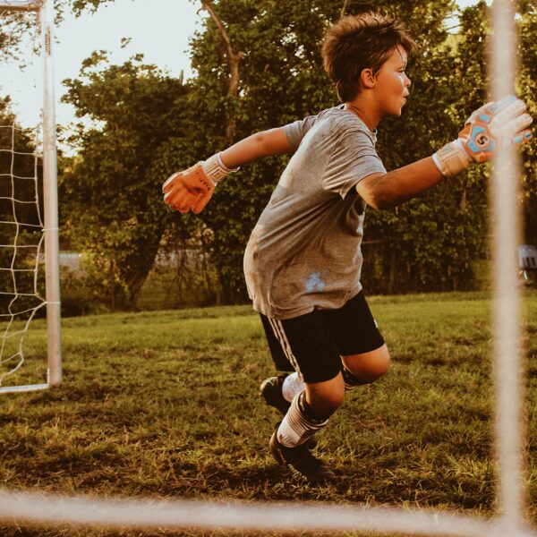 Child playing football as a goalkeeper