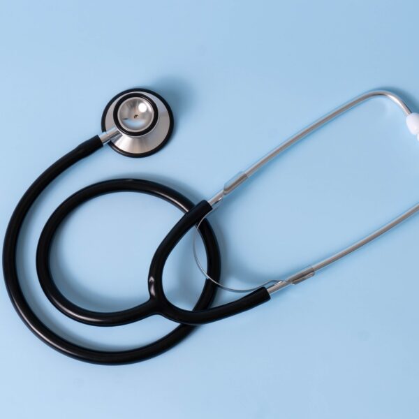 Simple stethoscope on a pastel blue background.