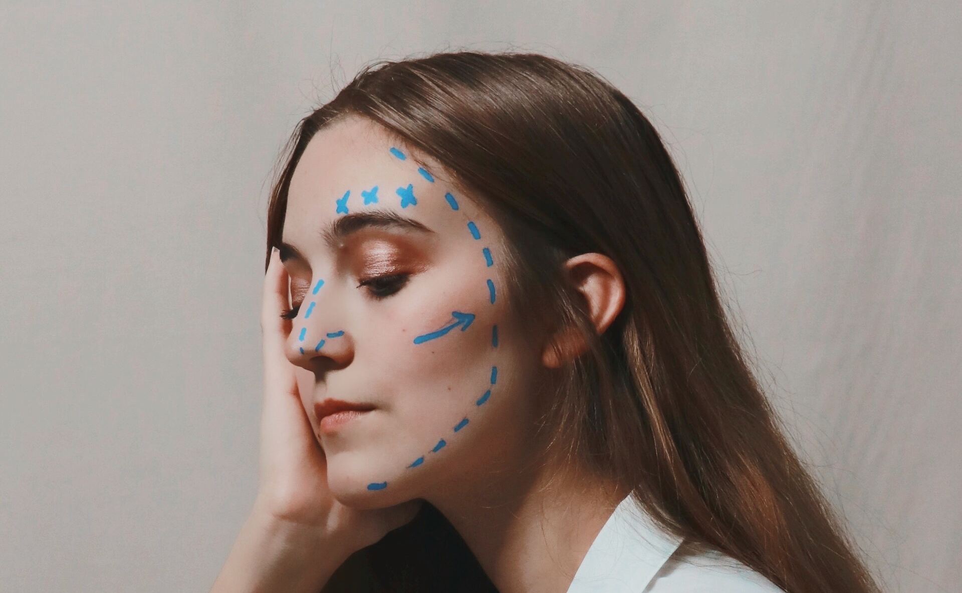 Woman with blue lines drawn on her face