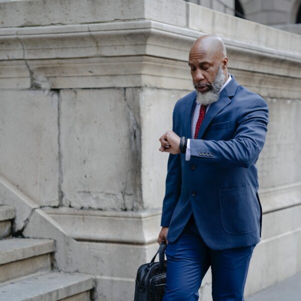 Man in a business suit checking his watch
