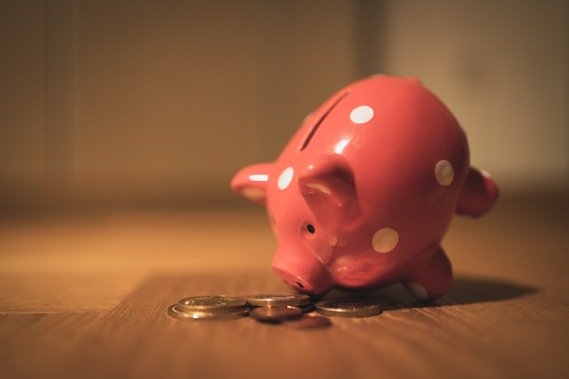 Pink piggy bank and coins