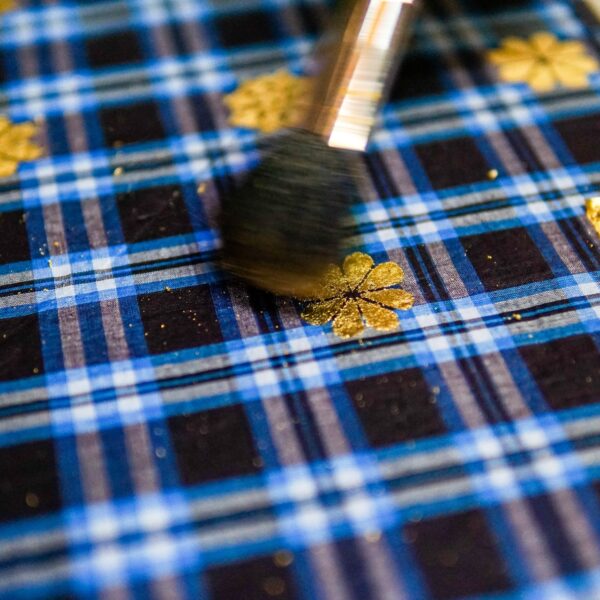 Gold leaf being used on fabric