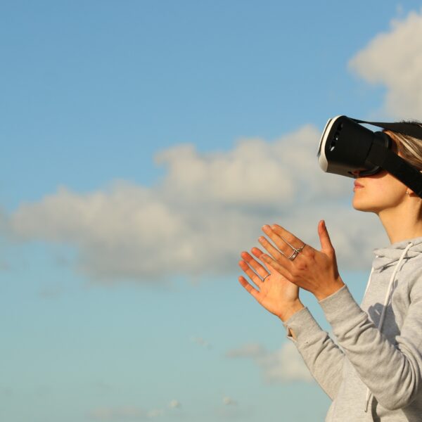 Woman using virtual reality headset outdoors