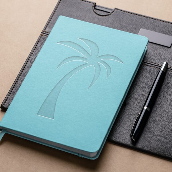 A beach theme planner on top of a black leather portfolio