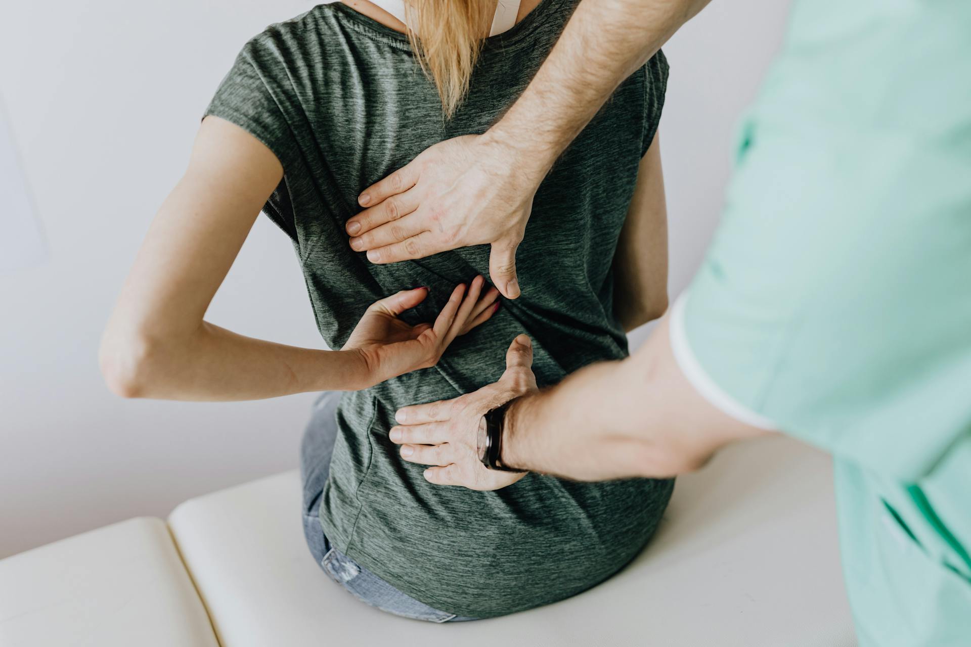 Chiropractor examining a woman's back