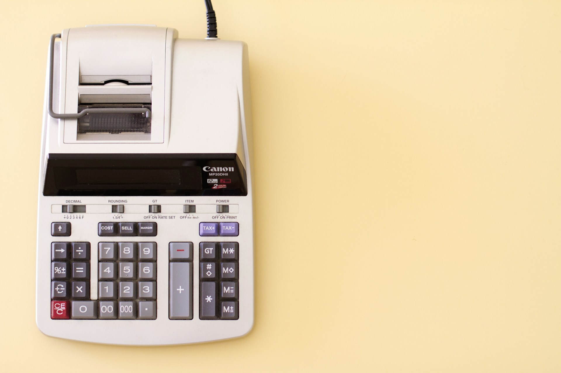 Canon MP20DH II accounting calculator on yellow desk